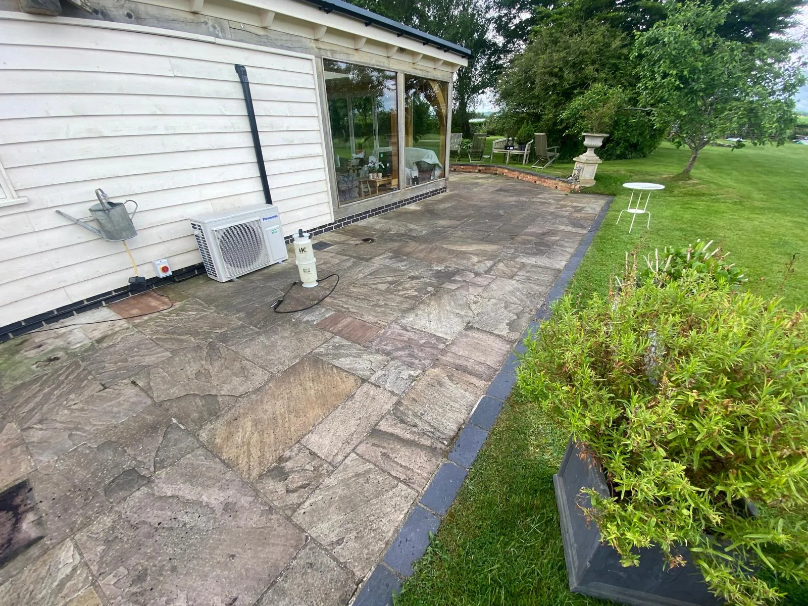 Indian sandstone patio before cleaning in Sutton Coldfield