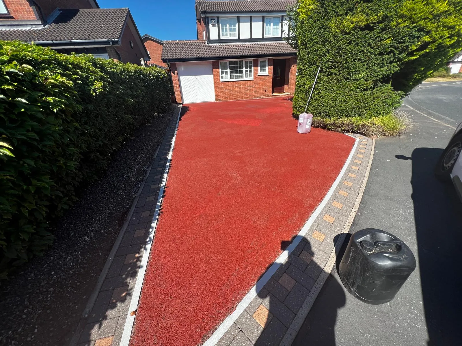 Red resin driveway after treatment with colour fully restored