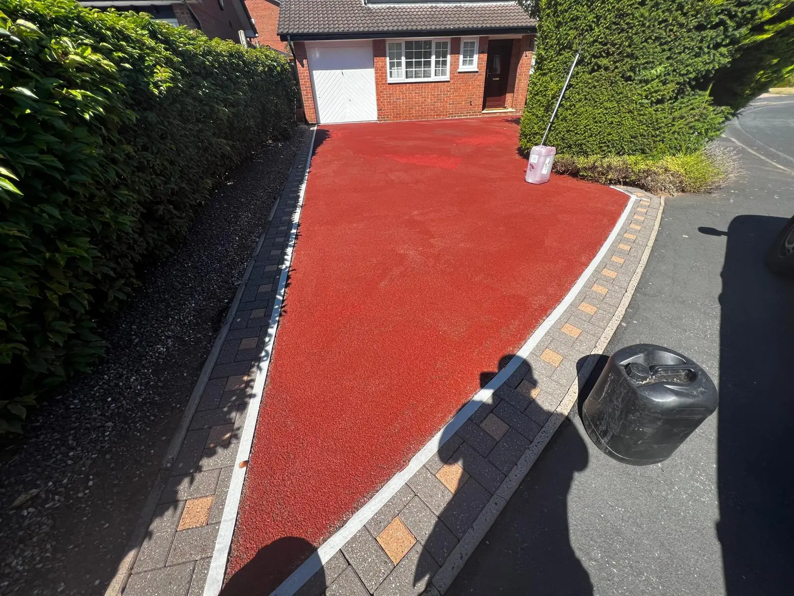 Red resin driveway fully recoloured with vibrant even finish