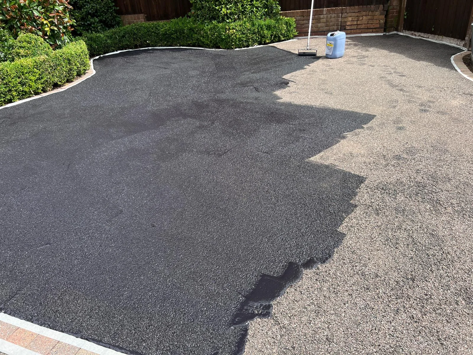 Faded grey tarmac driveway before restoration